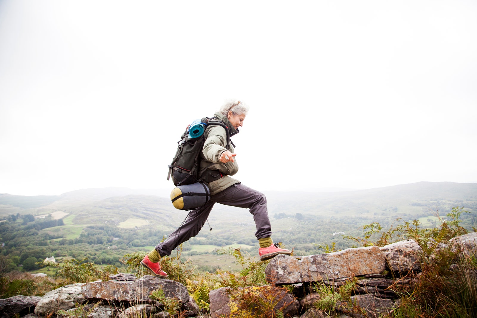 Concept art for best hiking backpacks for women Older woman trekking in mountains